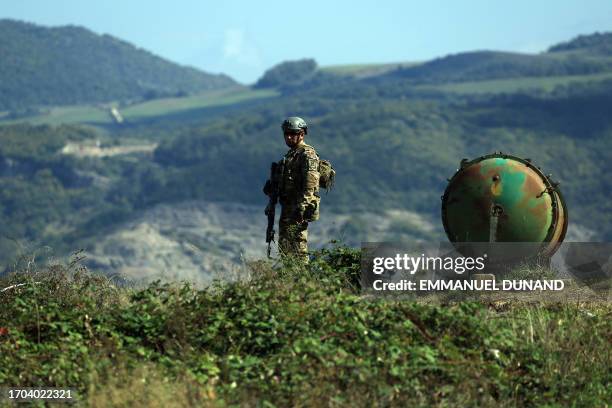An Azeri serviceman is seen at a former Armenian separatists military position in the village of Mukhtar retaken recently by Azeri troops, during an...