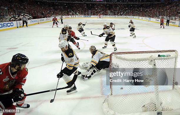 Johnny Oduya of the Chicago Blackhawks scores a goal in the third period against goalie Tuukka Rask of the Boston Bruins in Game One of the NHL 2013...