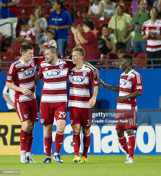 Kenny Cooper of FC Dallas celebrates his second goal of the game with teammates Eric Hassli, Michel and Fabian Castillo against the Houston Dynamo on...