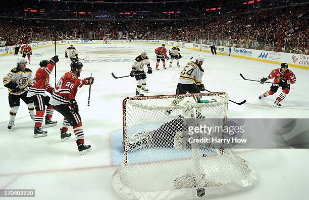 Dave Bolland of the Chicago Blackhawks scores a goal in the third period against goalie Tuukka Rask of the Boston Bruins in Game One of the 2013 NHL...