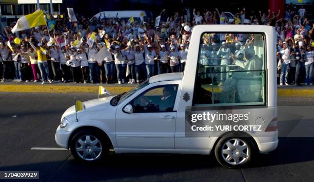 The popemobile of Pope Benedict XVI drives along Lopez Mateos Boulevard in the City of Leon, Mexico on March 23, 2012. The Pope arrived in Mexico...