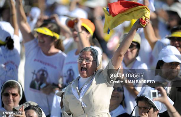 Nun celebrates before the arrival of Pope Benedict XVI at Revolution Square in Havana to celebrate mass, on March 28, 2012. Pope Benedict XVI was to...