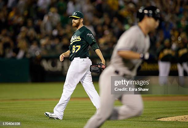 Dan Straily of the Oakland Athletics reacts after Jayson Nix of the New York Yankees hit a single that scored Kevin Youkilis in the seventh inning at...