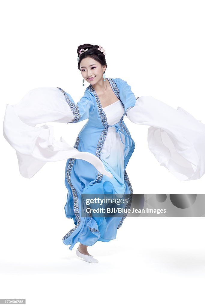 Happy young woman dancing in traditional Chinese costume