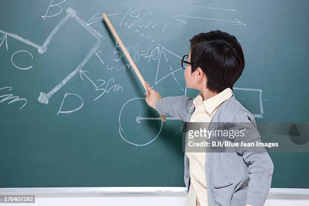active little boy playing teacher in classroom - pointer stick stock pictures, royalty-free photos & images