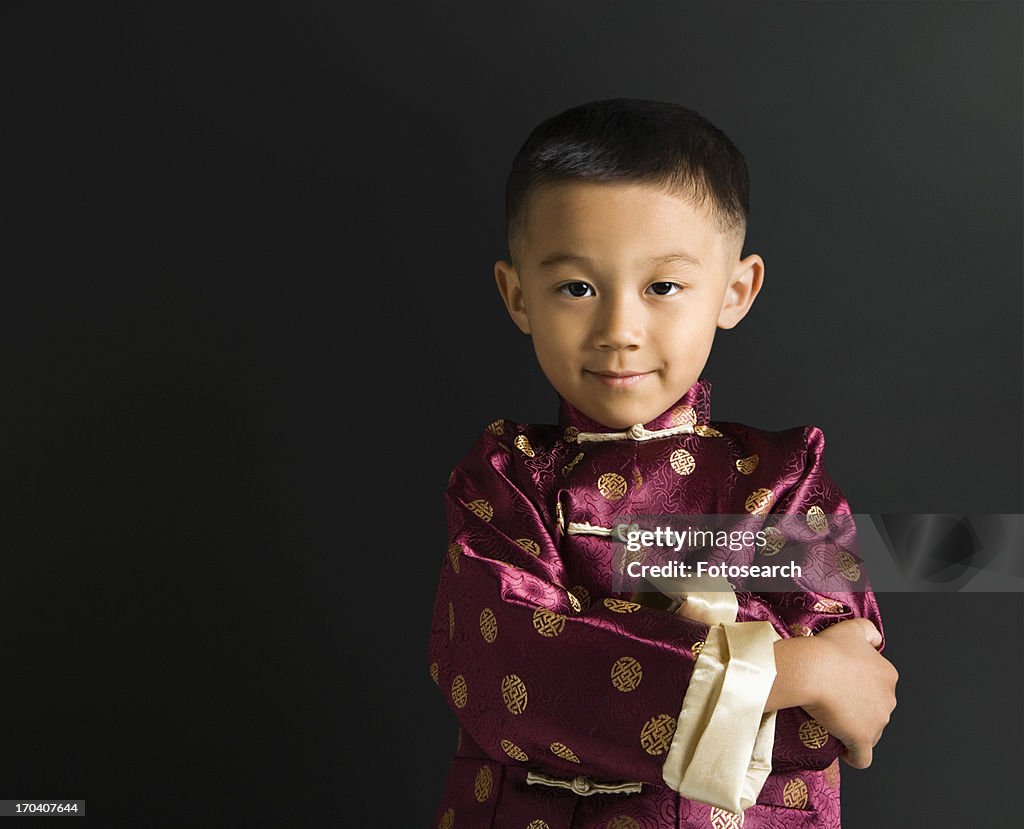 Boy in traditional attire standing