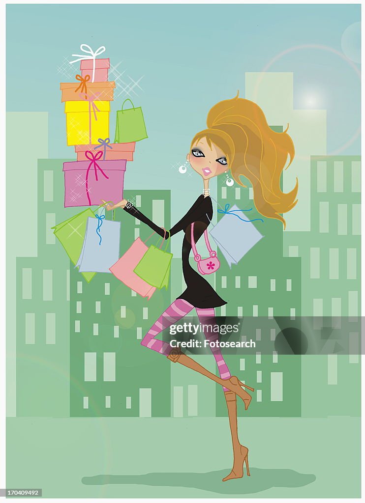 Woman in a cityscape walking with boxes and shopping bags