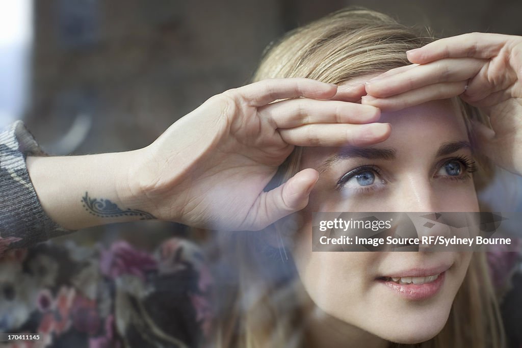 Woman peering through window