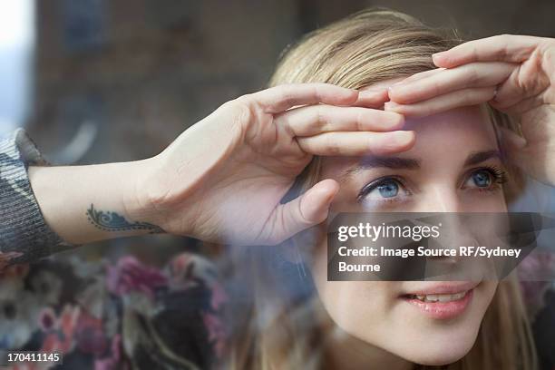 Woman peering through window