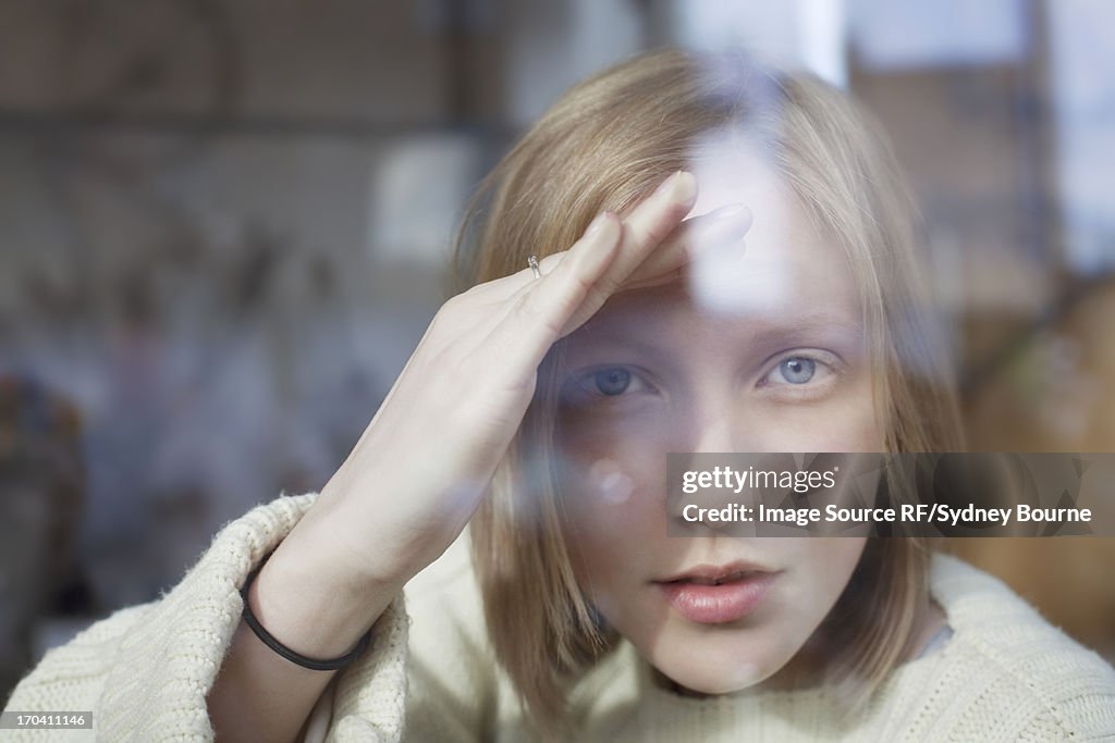 Woman peering through window