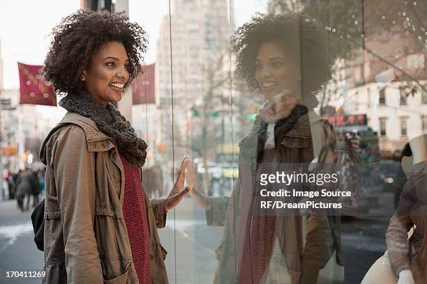 woman window shopping on city street - store window stock pictures, royalty-free photos & images