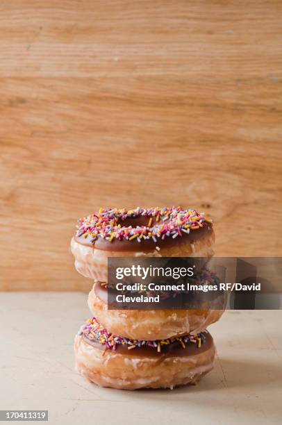 stack of decorated doughnuts - stack of donuts stock pictures, royalty-free photos & images