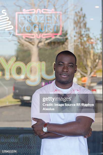 man standing by frozen yogurt store - rf business stock pictures, royalty-free photos & images