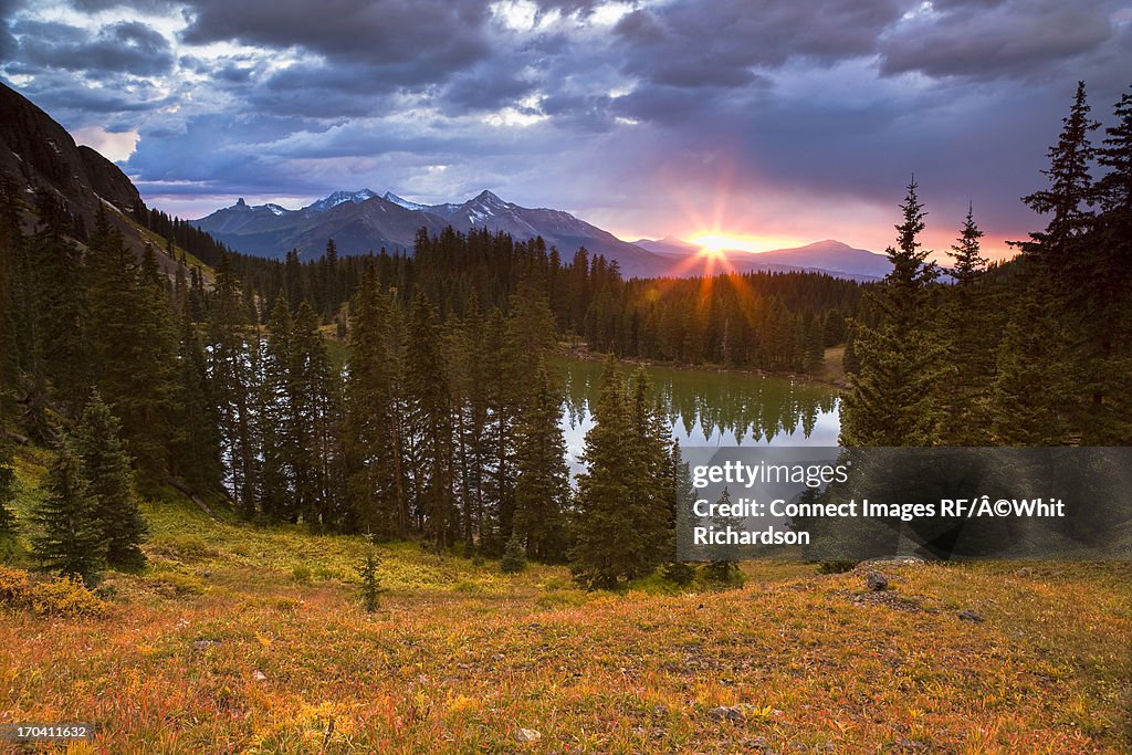Sun setting over still rural lake