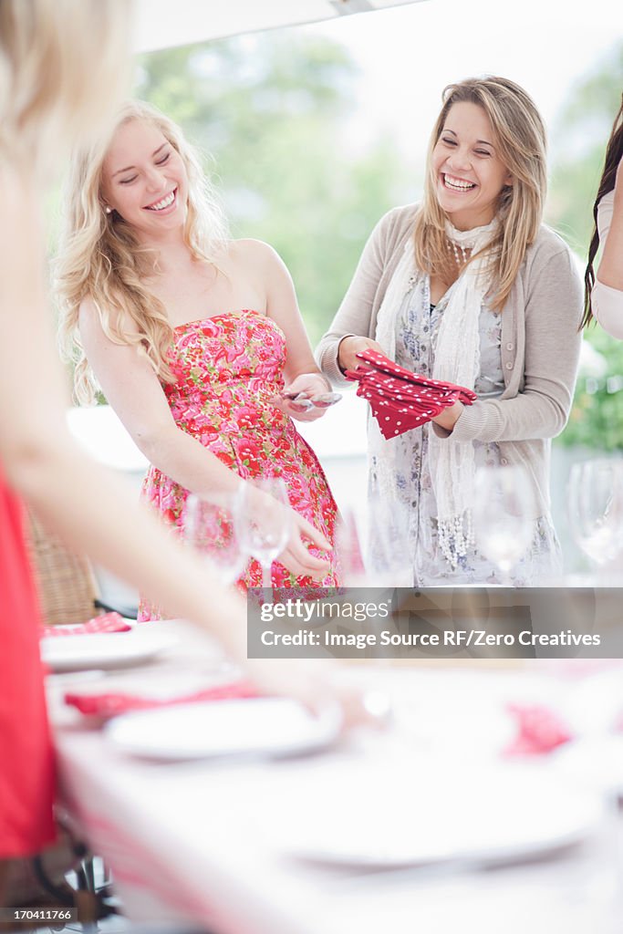 Women setting table outdoors