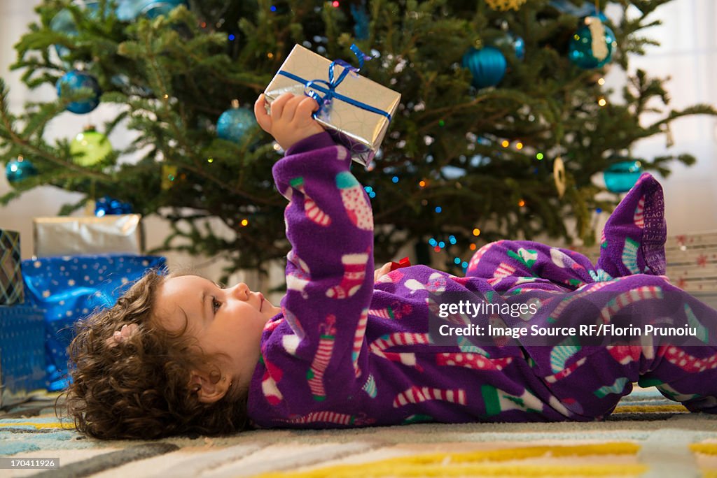 Toddler girl opening Christmas gifts