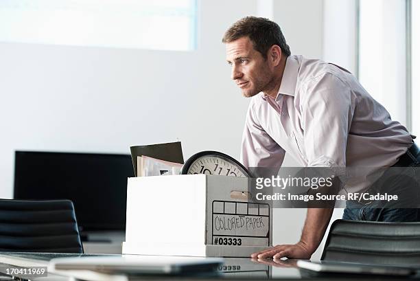 businessman packing up box in office - rf business stock pictures, royalty-free photos & images