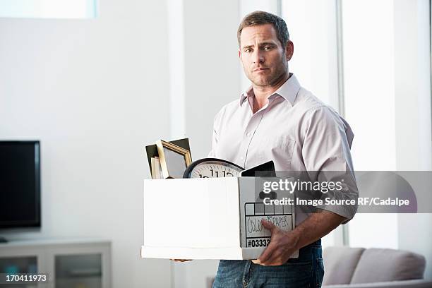 businessman packing up box in office - rf business stock pictures, royalty-free photos & images