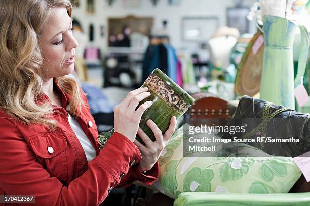 woman shopping in thrift store - antique shop stock pictures, royalty-free photos & images