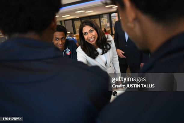 Britain's Home Secretary Suella Braverman shakes hands at the end of a game of table football during a visit to Bolton Lads and Girls Club in Bolton,...