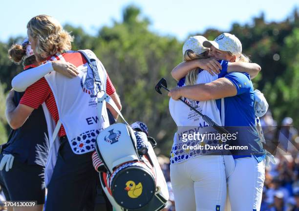 Caroline Hedwall of The European Team embraces her caddie on the 18th hole after winning her match against Ally Ewing during the final day singles...
