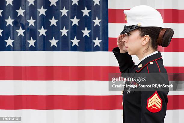 servicewoman in dress blues by us flag - marine corps flag stockfoto's en -beelden