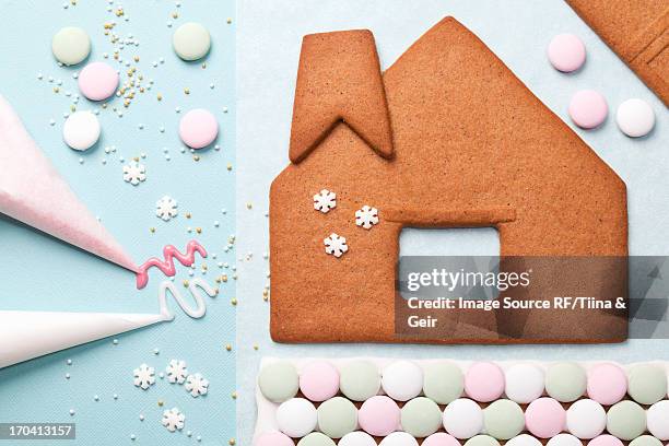 gingerbread house components on table - gingerbread house stock-fotos und bilder