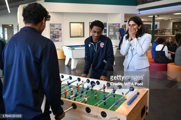 Britain's Home Secretary Suella Braverman reacts after conceding a goal during a game of table football during a visit to Bolton Lads and Girls Club...