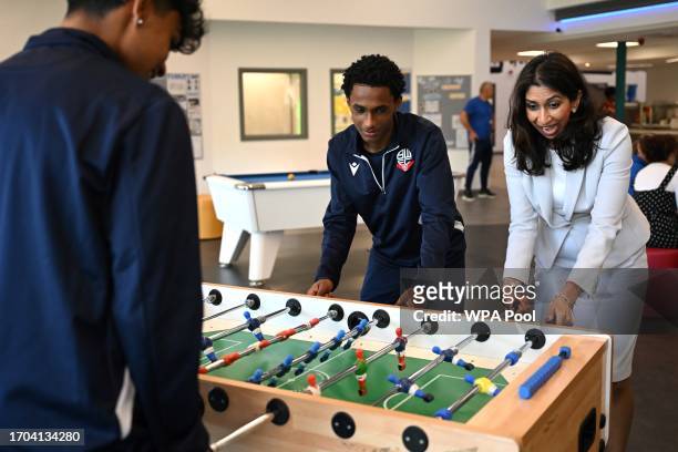 Britain's Home Secretary Suella Braverman plays table football during a visit to Bolton Lads and Girls Club on October 3, 2023 in Bolton, England.