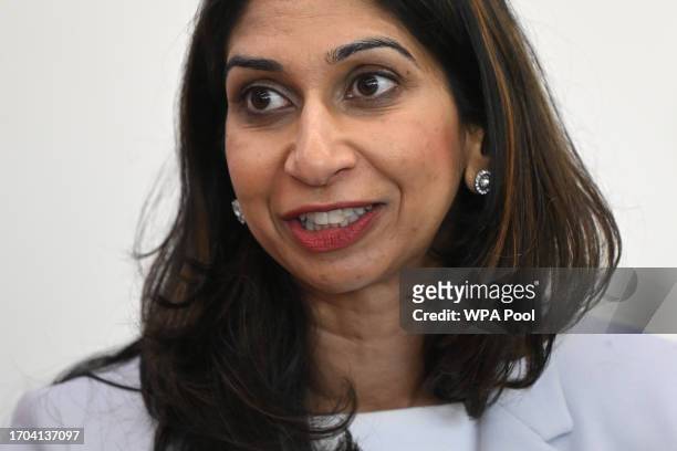 Britain's Home Secretary Suella Braverman speaks to volunteers during a visit to Bolton Lads and Girls Club on October 3, 2023 in Bolton, England.