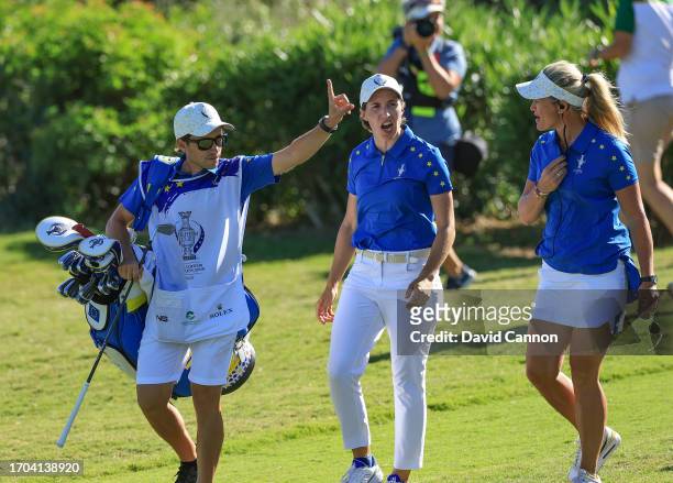 Carlota Ciganda of The European Team walks up to the green with Suzann Pettersen after hitting her tee shot close on the 17th hole in her match...