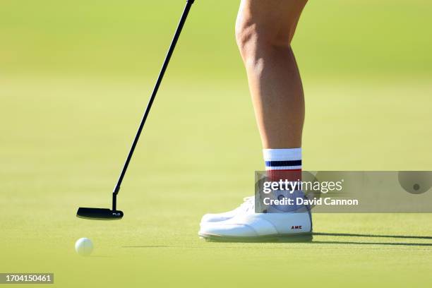 Detail photograph of the golf shoes belonging to Ally Ewing of The United States team as she hits a putt on the 14th hole in her match with Nelly...
