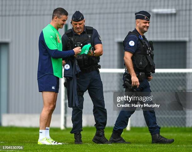 Tours , France - 3 October 2023; Jonathan Sexton signs autographs for the police during an Ireland Rugby squad training session at Complexe de la...