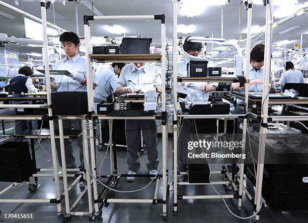 Workers assemble Panasonic Corp.'s Let's Note laptop computers on the production line at the company's plant in Kobe City, Hyogo Prefecture, Japan,...