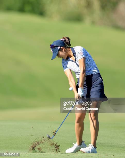 Andrea Lee of The United States team plays her second shot on the ninth hole in her match with Rose Zhang against Madelene Sagstrom and Emily...