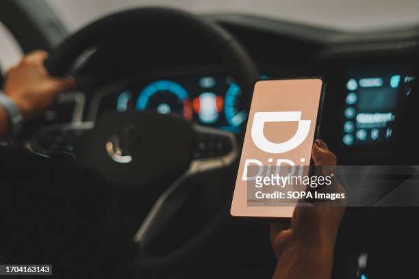 In this photo illustration, the Didi Chuxing logo is seen displayed on a smartphone screen.