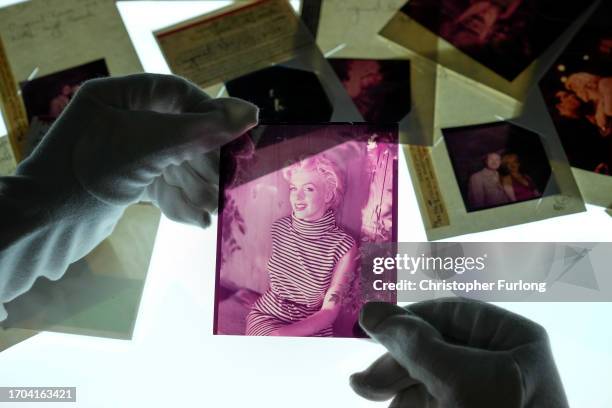 Curatorial assistant holding colour transparencies by the photographer Baron, depicting Marilyn Monroe, at the Getty Images Hulton Archive, London...