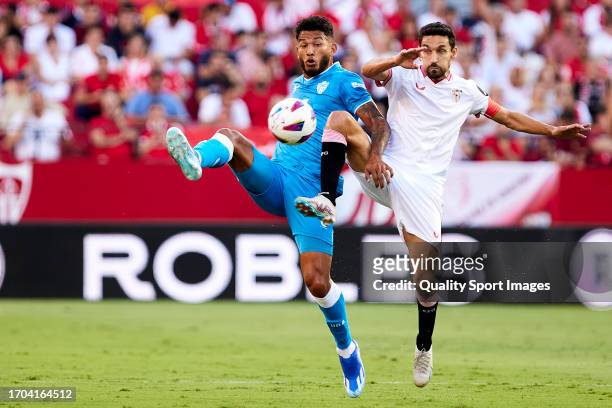 Jesus Navas of Sevilla FC competes for the ball with Luis Suarez of UD Almeria during the LaLiga EA Sports match between Sevilla FC and UD Almeria at...