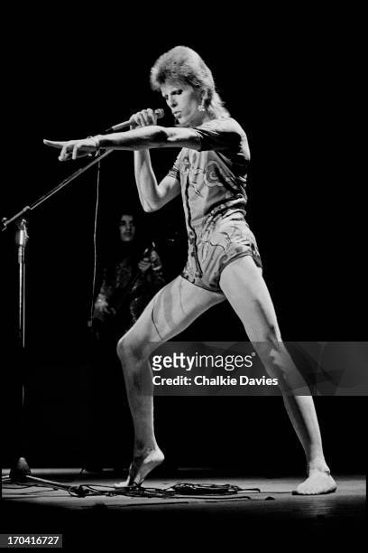 David Bowie performs on stage at Hammersmith Odeon on the last night of the Ziggy Stardust Tour, London, 3rd July 1973. At the end of the show David...
