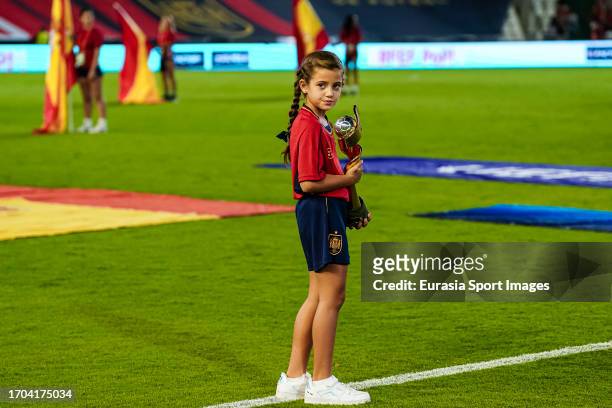Little girl volunteer getting into the field with the FIFA Womens World Cup 2023 trophy won by Spain prior the UEFA Women's Nations League Group D...