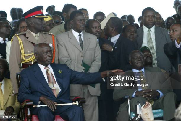 Outgoing Kenyan President Daniel arap Moi sits next to President-elect Mwai Kibaki during a swearing-in ceremony December 30, 2002 in Nairobi, Kenya....