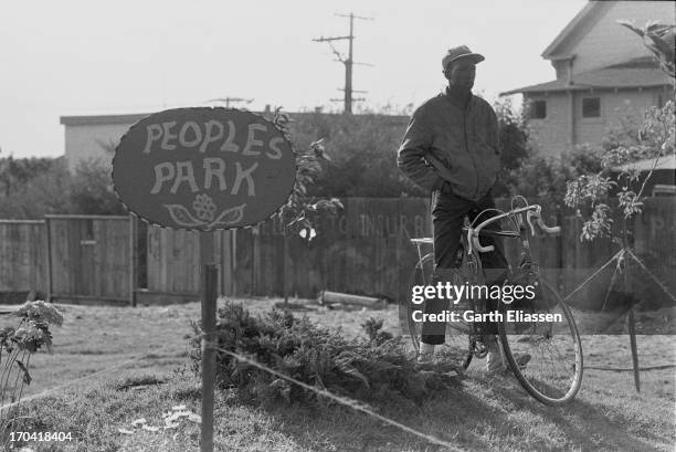Man with a bicycle stands beside a sign at the People's Park II , Berkeley, California, June 2, 1969. The Annex, located on the Hearst Corridor...