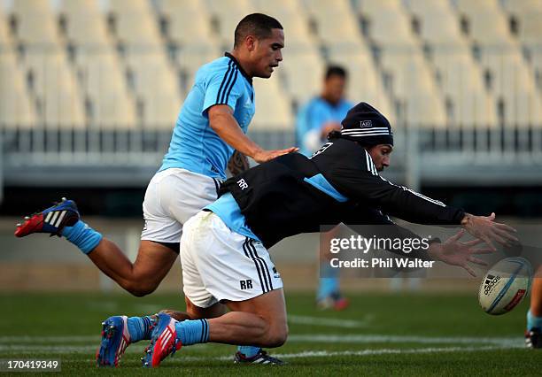 Rene Ranger of the All Blacks gets to the ball ahead of Aaron Smith during a New Zealand All Blacks training session at AMI Stadium on June 13, 2013...