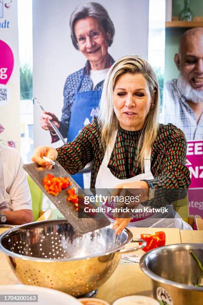 Queen Maxima of The Netherlands visits initiatives that reduce loneliness and join the ladies of Oma Soup that prepares soups in a community center...