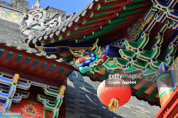 chinese lanterns hang under eaves - shanghai temple stock pictures, royalty-free photos & images