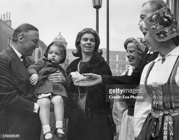 Princess Margaretha of Sweden and her husband John Ambler holding their daughter Sibylla Louise Ambler, are greeted by women in Swedish National...