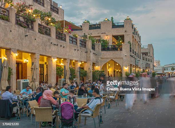 people dining and smoking  hookah in souk waqif - souk stock pictures, royalty-free photos & images