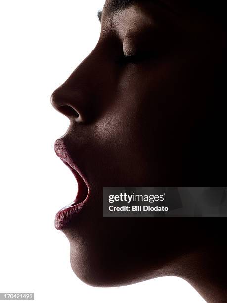 silhouette of woman with open mouth - face and profile and mouth open stock-fotos und bilder