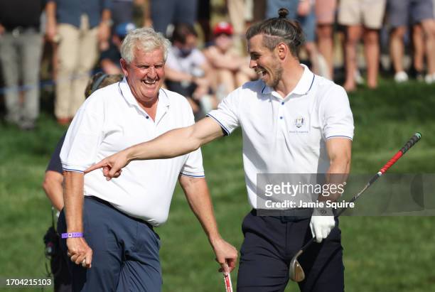 Former footballer, Gareth Bale and Colin Montgomerie of Scotland talk during the All-Star Match at the 2023 Ryder Cup at Marco Simone Golf Club on...