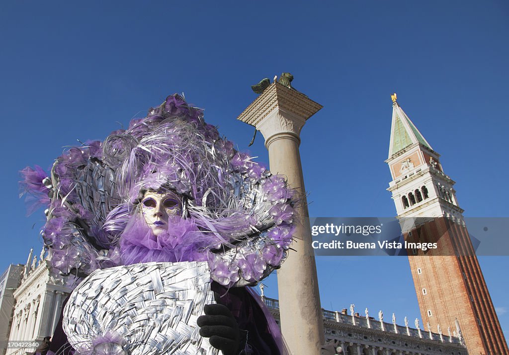 Carnival mask in Venice posing in San Marco square